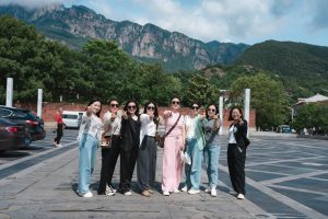Group of friends posing in front of mountains